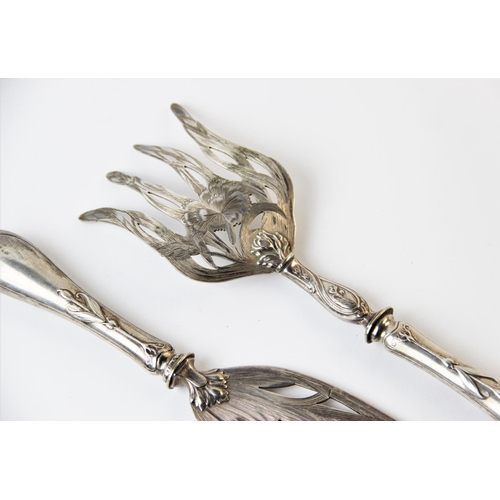 128 - A pair of continental Art Nouveau fish servers, each finely pierced with pinks and scrolling foliage... 