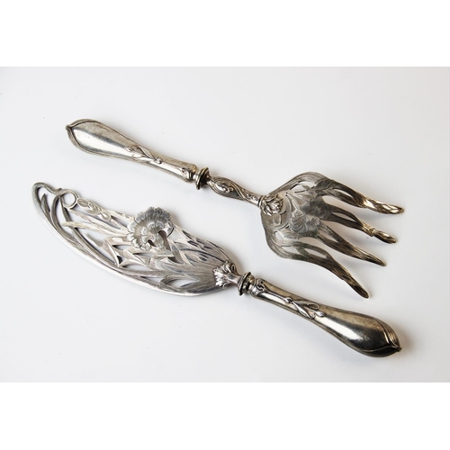 128 - A pair of continental Art Nouveau fish servers, each finely pierced with pinks and scrolling foliage... 