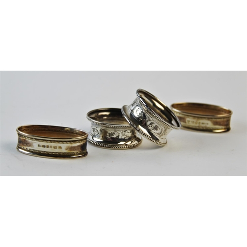 136 - A pair of silver napkin rings Rolason Brothers Birmingham 1925, each with engraved foliate decoratio... 