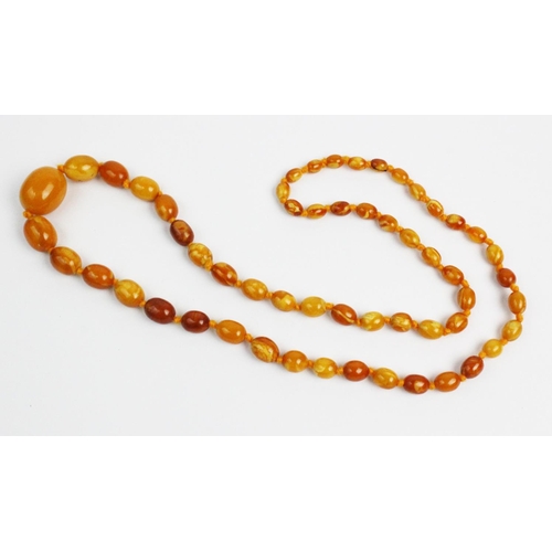 174 - A butterscotch amber necklace, designed as a single strand of fifty six graduated beads, gross weigh... 