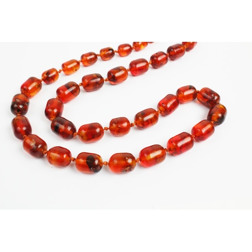 176 - A 'Cracked' amber bead necklace, designed as a single strand of thirty seven beads, gross weight 73.... 