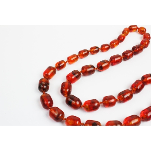 176 - A 'Cracked' amber bead necklace, designed as a single strand of thirty seven beads, gross weight 73.... 