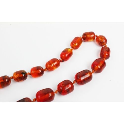 176 - A 'Cracked' amber bead necklace, designed as a single strand of thirty seven beads, gross weight 73.... 