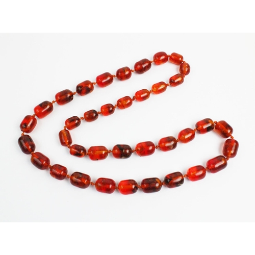 176 - A 'Cracked' amber bead necklace, designed as a single strand of thirty seven beads, gross weight 73.... 