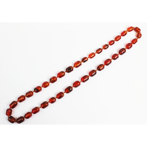 176 - A 'Cracked' amber bead necklace, designed as a single strand of thirty seven beads, gross weight 73.... 