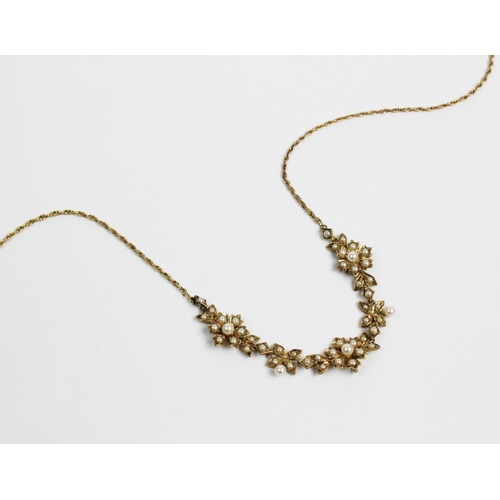 178 - A Victorian style 9ct gold and split seed pearl set necklace, designed as three floral clusters, joi... 