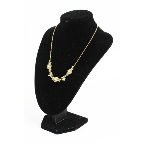 178 - A Victorian style 9ct gold and split seed pearl set necklace, designed as three floral clusters, joi... 