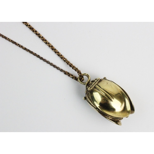 180 - A silver gilt watch pendant on chain, designed as a hanging fruit with three hinged locket 'leaf' si... 