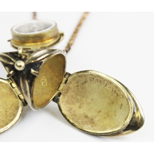 180 - A silver gilt watch pendant on chain, designed as a hanging fruit with three hinged locket 'leaf' si... 