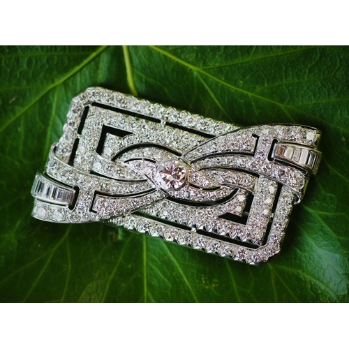 198 - A diamond set Art Deco brooch, the rectangular brooch with central stylised bow 'twist', set through... 