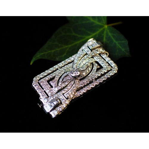 198 - A diamond set Art Deco brooch, the rectangular brooch with central stylised bow 'twist', set through... 