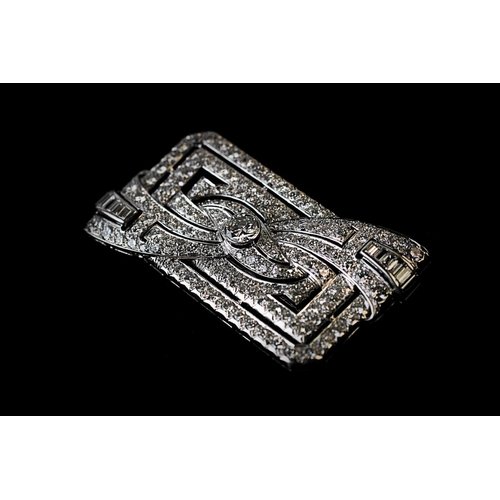 198 - A diamond set Art Deco brooch, the rectangular brooch with central stylised bow 'twist', set through... 