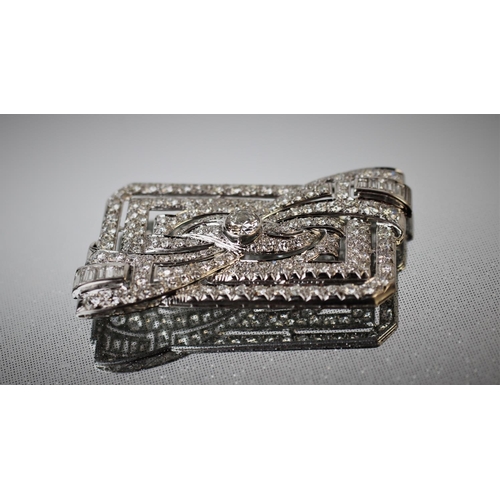 198 - A diamond set Art Deco brooch, the rectangular brooch with central stylised bow 'twist', set through... 