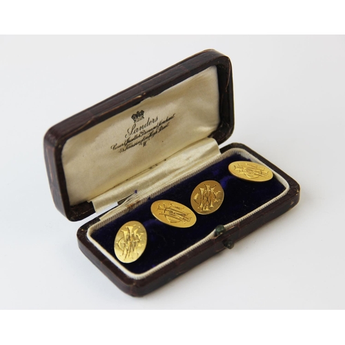 203 - A pair of yellow metal cufflinks, stamped '18ct', each oval disc (monogrammed) joined by a bar link,... 