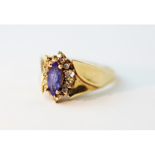 218 - An amethyst set dress ring, designed as a central marquise cut stone, within a further stone set bor... 