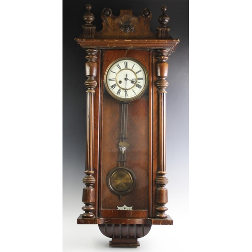 368 - A Victorian walnut Vienna wall clock, the architectural case with turned fluted columns flanking the... 