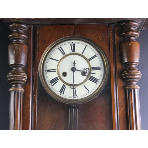 368 - A Victorian walnut Vienna wall clock, the architectural case with turned fluted columns flanking the... 