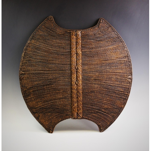 409 - A Mambila 'Kor' Shield, Cameroon, with wood and braided palm fibre body, decorated with geometric pa... 