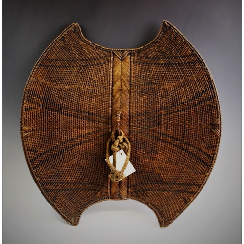 409 - A Mambila 'Kor' Shield, Cameroon, with wood and braided palm fibre body, decorated with geometric pa... 