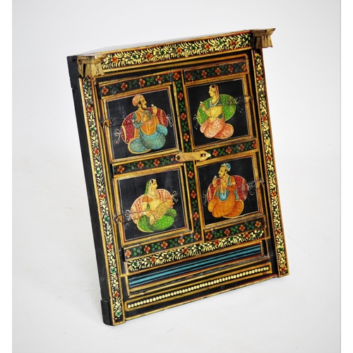 428 - A painted Indian hardwood cabinet, 20th century, the pair of doors with two panels each applied with... 