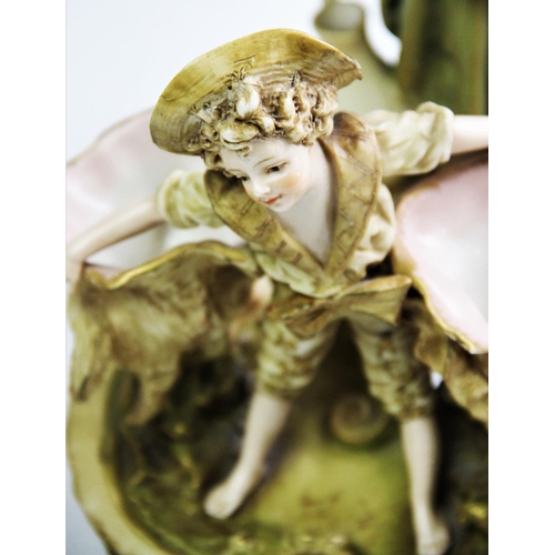 512 - An Ernst Wahliss porcelain figurine, late 19th/early 20th century, modelled as a flower boy holding ... 