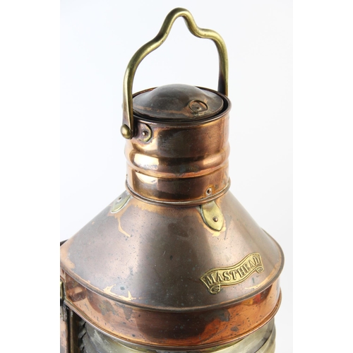 538 - A late 19th/early 20th century ships copper masthead lantern, with a brass swing handle above a bras... 