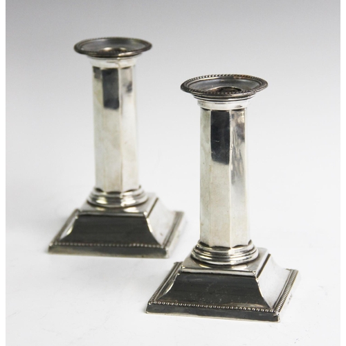 63 - A pair of Victorian silver candlesticks, Mappin & Webb Sheffield 1895 and 1896, each of octagonal co... 