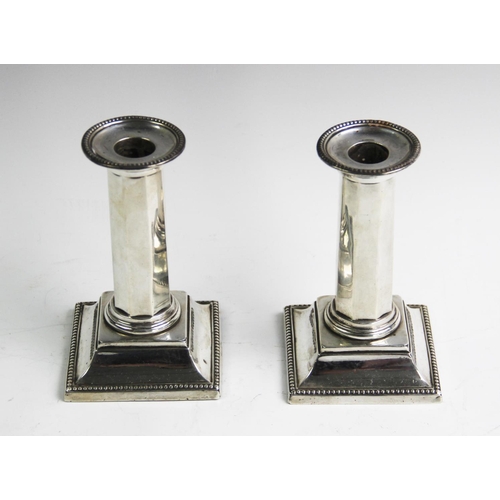 63 - A pair of Victorian silver candlesticks, Mappin & Webb Sheffield 1895 and 1896, each of octagonal co... 