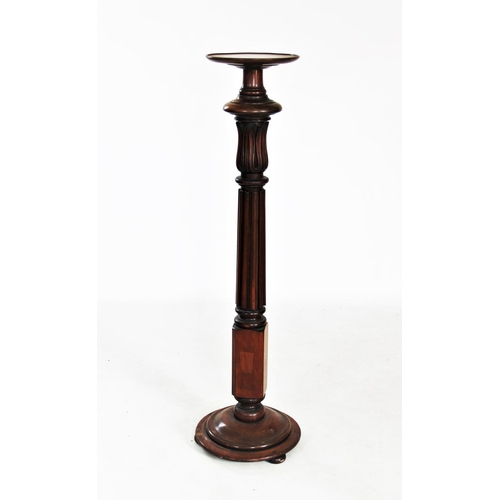 717 - A 19th century mahogany torchere, with reeded acanthus leaf pedestal upon a circular plinth base wit... 