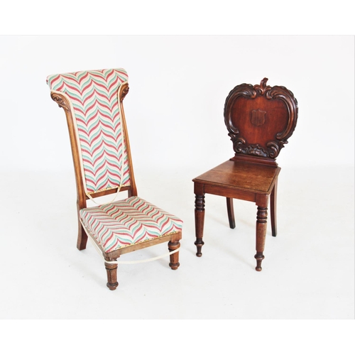 724 - A Victorian mahogany hall chair, the apple shaped back applied with 'C' scroll carving and centred w... 