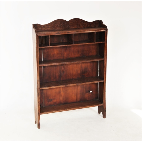 731 - A late 19th/early 20th century oak open bookcase, with a shaped gallery above four pigeon holes and ... 