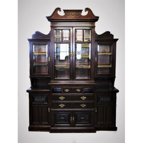 750 - An Edwardian mahogany breakfront display cabinet, with a twin swan neck pediment above a pair of bev... 