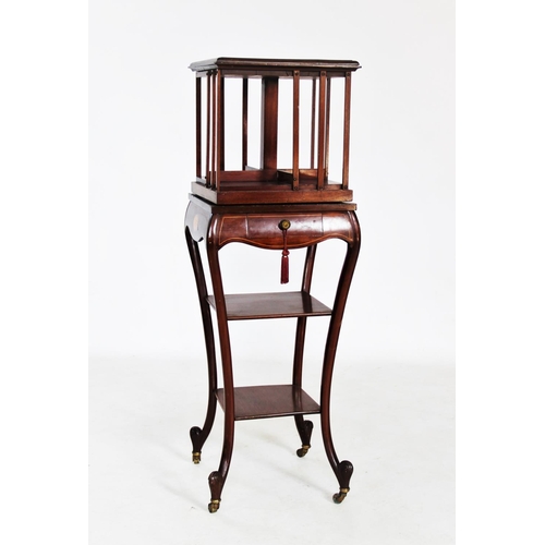 758 - An Edwardian inlaid mahogany revolving bookcase on stand, the square moulded top centred with an inl... 