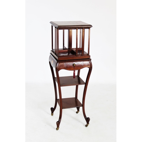 758 - An Edwardian inlaid mahogany revolving bookcase on stand, the square moulded top centred with an inl... 