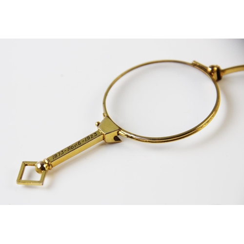 272 - A gilt metal lorgnette engraved 'EAC - MMR 1873-1923' 8.5cm long and a gold mounted miniature glass ... 