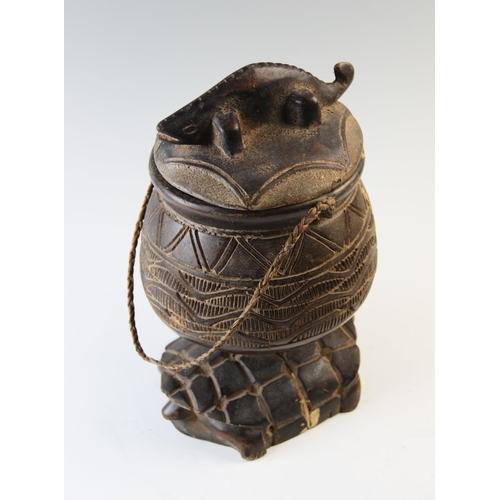 411 - A carved zoomorphic Ashanti container and cover, the removable cover with a carved crocodile finial,... 