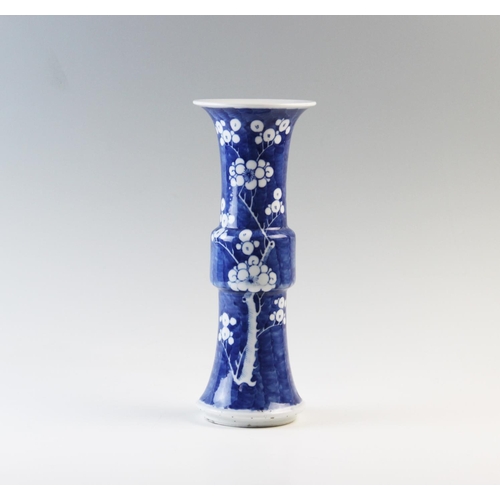 436 - A Chinese blue and white prunus Gu vase, 19th century, of typical phoenix tail form, double concentr... 