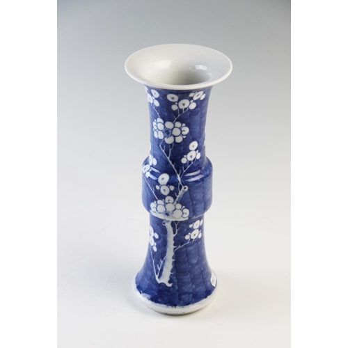 436 - A Chinese blue and white prunus Gu vase, 19th century, of typical phoenix tail form, double concentr... 