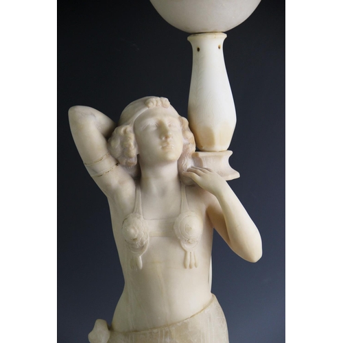 533 - An Art Deco alabaster figural lamp, modelled as an Egyptian revival dancing girl, arms raised, below... 