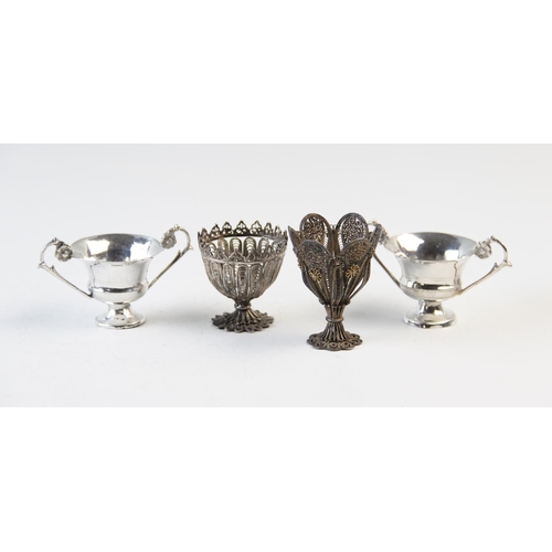 73 - Two filligree zarf type cups, 4.5cm and 6cm high, and two Italian silver two handled miniature troph... 