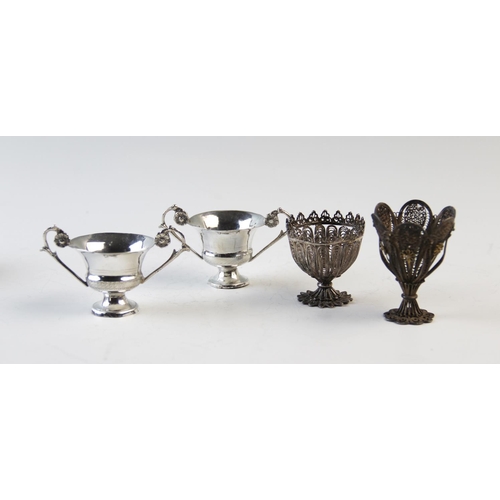 73 - Two filligree zarf type cups, 4.5cm and 6cm high, and two Italian silver two handled miniature troph... 