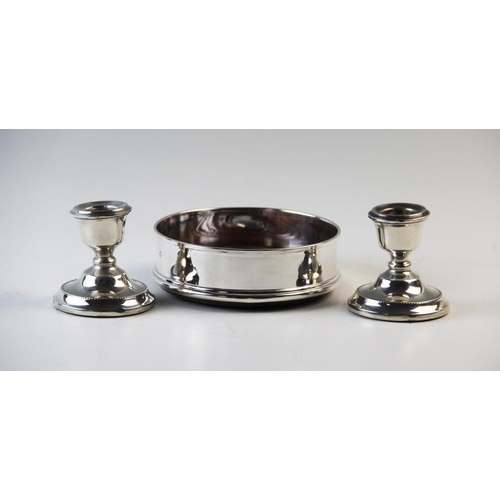 84 - A silver mounted wine coaster London 2000, with turned oak base, 12.5cm diameter with a pair of silv... 