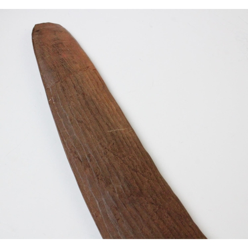 415 - An Aboriginal boomerang, 20th century, with fluted carving to the upper side, 61cm long