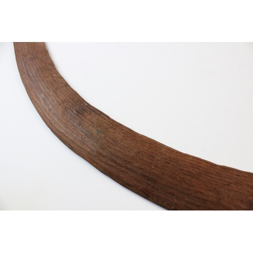 415 - An Aboriginal boomerang, 20th century, with fluted carving to the upper side, 61cm long