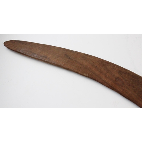 415 - An Aboriginal boomerang, 20th century, with fluted carving to the upper side, 61cm long