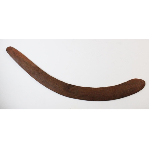 415 - An Aboriginal boomerang, 20th century, with fluted carving to the upper side, 61cm long