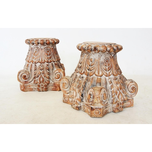 429 - A pair of Rajasthan hardwood column capitals, each of tapering form with carved corner scrolls and s... 