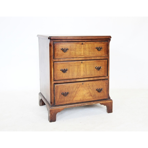 711 - An 18th century style burr walnut chest of drawers, the quarter veneered and cross banded top above ... 