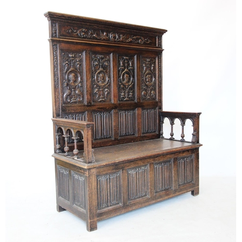 713 - A late Victorian carved oak box settle, in the 17th century style, the high back with four panels ea... 