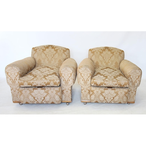 768 - A pair of 1930's deep seated fireside armchairs, covered in foliate pattern fabric, raised upon late... 